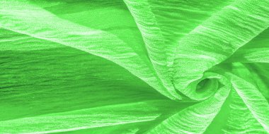 İpek kumaş. Yeşil kırışık kumaş dokusu. Yeşil buruşuk, dalgalı yüzey dokusu. Yakın çekim, yumuşak odaklanma. arkaplan, kalıp