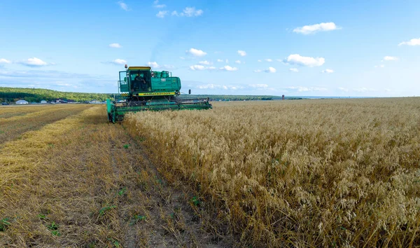 stock image Summer photo of barley harvesting, Combine Harvester is a mechanized method that combines the process of harvesting, threshing and winding crops  