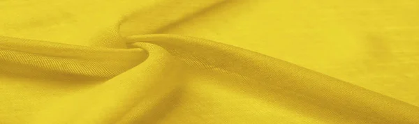 stock image silk fabric in yellow. texture, dense, Abstract smooth silk fabric. beautiful bend. close-up. - Image