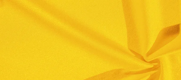 stock image Yellow silk. Smooth elegant yellow luxurious silk fabric can be used as an abstract background with copy space, close up. colorful texture