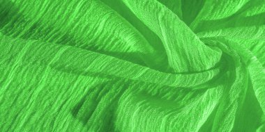 İpek kumaş. Yeşil kırışık kumaş dokusu. Yeşil buruşuk, dalgalı yüzey dokusu. Yakın çekim, yumuşak odaklanma. arkaplan, kalıp