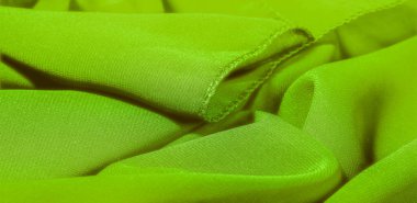 Kumaşın kenarında püsküllü yeşil ipek bir şal. Bu yaygın bir kravat türüdür. Beyaz arka planda sıcak yeşil. Şablon