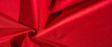 Kırmızı ipek. Soyut bir arka plan olarak, lüks kırmızı ipeğin veya satenin dokusunu kullanabilirsiniz. Renkli doku, arkaplan, desen
