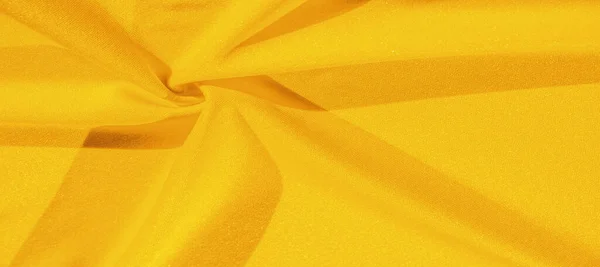 stock image Yellow silk. Smooth elegant yellow luxurious silk fabric can be used as an abstract background with copy space, close up. colorful texture