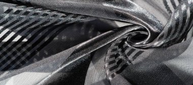 Arka plan dokusu, desen, koleksiyon, farklı boyutlarda çizgileri olan şeffaf ipek kumaş, siyah, zarif lüks.