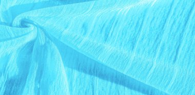 İpek kumaş. Mavi buruşuk kumaş dokusu. Mavi buruşuk, dalgalı yüzey dokusu. Yakın çekim, yumuşak odaklanma. arkaplan, kalıp