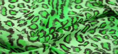 İpek kumaş yeşil, leopar desenli. Hafif leopar desenli ipek senin tasarımın için mükemmel, şık görünüyor ve kaba değil! Doku, arkaplan, desen