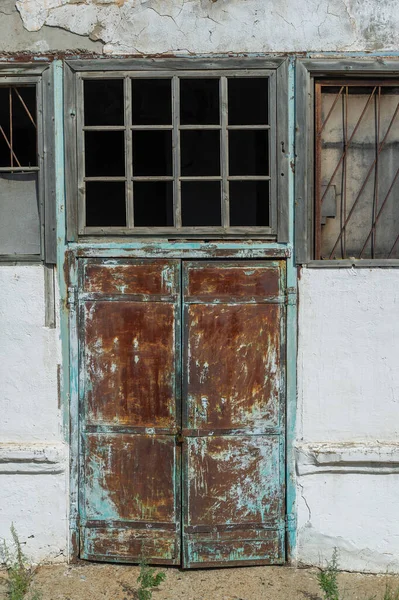 Architectural concept: an old building with vintage charm Design elements include iron doors and windows with bars for added security Whitewashed walls create a rustic and clean aesthetic