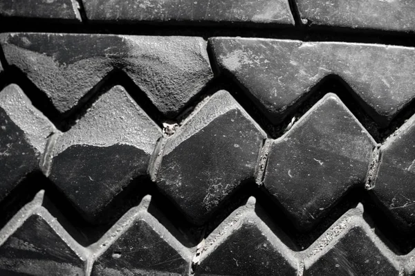 Create a unique texture with a worn tire tread pattern. Use as background for automotive or industrial design. Print on clothing, accessories or packaging for a rugged look
