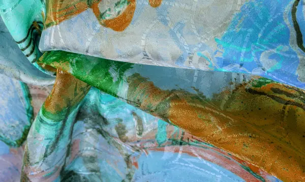 silk fabric in a palette drawn by the artist, bright colors, brown-yellow blue color, unbridled fantasy, texture, background, pattern, wallpaper