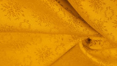 Sarı kumaş. Kehribar turuncu. Soyut doku. Kumaş liflerinden yapılmış renkli yüzey. Doku, arkaplan, desen