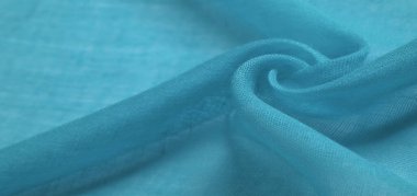 Mavili ipek kumaş. Pürüzsüz mavi ipek ya da lüks saten kumaş dokusu soyut bir arkaplan olarak kullanılabilir. Lüks Noel arkaplanı
