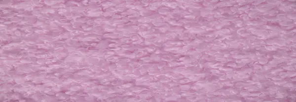 Faux fur in pale pink color. Imitation of karakul lamb skin. known as fleecy fabric, which resembles animal fur in appearance and warmth.