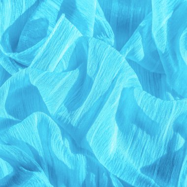 İpek kumaş. Mavi buruşuk kumaş dokusu. Mavi buruşuk, dalgalı yüzey dokusu. Yakın çekim, yumuşak odaklanma. arkaplan, kalıp