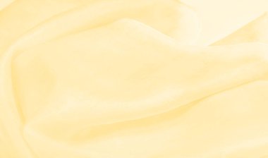 Bulanık sarı ipek kumaş. Kremsi bej rengini ve ışıldayan saten kaplamasını gösteriyor. Hala şifonun ve akıcı kumaşın tipik tazeliğini koruyor..