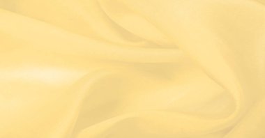 Bulanık sarı ipek kumaş. Kremsi bej rengini ve ışıldayan saten kaplamasını gösteriyor. Hala şifonun ve akıcı kumaşın tipik tazeliğini koruyor..