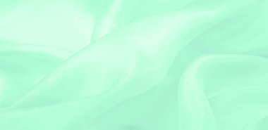 Bulanık yeşil ipek kumaş. Yumuşak ipek dokuma ile sıcak yeşil bir renk gösteren saten dokuma bu maddenin yüzeyine muhteşem bir parıltı ekler..