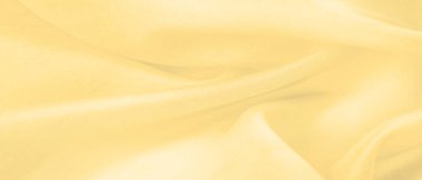 Bulanık sarı ipek kumaş. Kremsi bej rengini ve ışıldayan saten kaplamasını gösteriyor. Hala şifonun ve akıcı kumaşın tipik tazeliğini koruyor..