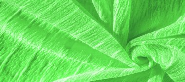 İpek kumaş. Yeşil kırışık kumaş dokusu. Yeşil buruşuk, dalgalı yüzey dokusu. Yakın çekim, yumuşak odaklanma. arkaplan, kalıp