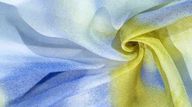 Yumuşak mavi, soyut desenleri ve yatak tonları olan ipek kumaş, sarı ve beyaz tonlarda. Doku, desen, koleksiyon