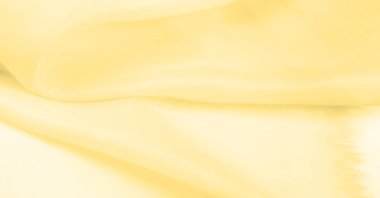 Bulanık sarı ipek kumaş. Kremsi bej rengini ve ışıldayan saten kaplamasını gösteriyor. Hala şifonun ve akıcı kumaşın tipik tazeliğini koruyor..