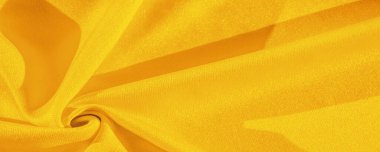Sarı ipek. Pürüzsüz, zarif, sarı, lüks ipek kumaş kopya alanı olan soyut bir arkaplan olarak kullanılabilir. Renkli doku