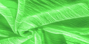 İpek kumaş. Yeşil kırışık kumaş dokusu. Yeşil buruşuk, dalgalı yüzey dokusu. Yakın çekim, yumuşak odaklanma. arkaplan, kalıp