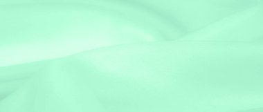 Bulanık yeşil ipek kumaş. Yumuşak ipek dokuma ile sıcak yeşil bir renk gösteren saten dokuma bu maddenin yüzeyine muhteşem bir parıltı ekler..