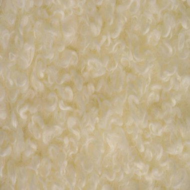 Beyaz soluk sarı renkli sahte kürk. Karakul kuzu derisinin taklidi. Görünüşü ve sıcaklığı hayvan kürküne benzeyen tüylü kumaş olarak bilinir..