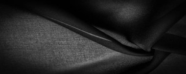 Koyu siyah şifon ipeği, bükülmüş iplik kullanımı nedeniyle hafif pürüzlü (matte, creped) yumuşak şeffaf bir kumaştır. Arkaplan dokusu