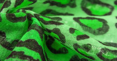 İpek kumaş yeşil, leopar desenli. Hafif leopar desenli ipek senin tasarımın için mükemmel, şık görünüyor ve kaba değil! Doku, arkaplan, desen
