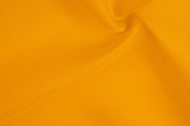 Güzel sarı ipek kumaş dekorasyon için mükemmeldir. Dokunmak için yumuşak ve lüks. Koyu kehribar rengi her yere sıcaklık ve zarafet ekler..