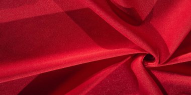 Kırmızı ipek. Soyut bir arka plan olarak, lüks kırmızı ipeğin veya satenin dokusunu kullanabilirsiniz. Renkli doku, arkaplan, desen