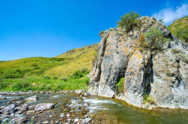 Nehir boyunca doğanın huzurlu güzelliğinin tadını çıkar. Etrafı görkemli dağlarla çevrili kayalık bir kanyonda dolaş. Nehrin huzurlu akışına kapıl.