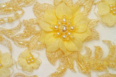 Çeşitli tasarım amaçları için altın sarısı dantel dokular. Kartpostallar için arka plan olarak kullanılabilir. Posterler. Dokular. ya da duvar kâğıdından karmaşık çizgileri olan eski dantel desenler.