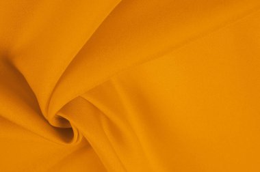 Güzel sarı ipek kumaş dekorasyon için mükemmeldir. Dokunmak için yumuşak ve lüks. Koyu kehribar rengi her yere sıcaklık ve zarafet ekler..