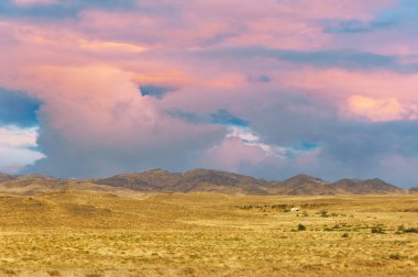 Steppe, prairie, plain, pampa. Embraced by the glowing warmth of the setting sun, the prairie whispers a sorrowful tale of yet another day gone by. Sunset Reflections clipart