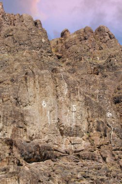 Improve your climbing skills with marked rocks. The white line indicates the best way to train. Ideal for both beginners and experienced climbers. clipart