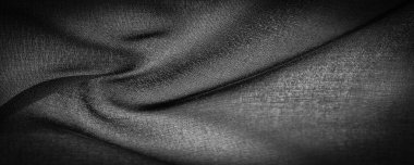 Koyu siyah şifon ipeği, bükülmüş iplik kullanımı nedeniyle hafif pürüzlü (matte, creped) yumuşak şeffaf bir kumaştır. Arkaplan dokusu
