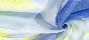 Yumuşak mavi, soyut desenleri ve yatak tonları olan ipek kumaş, sarı ve beyaz tonlarda. Doku, desen, koleksiyon