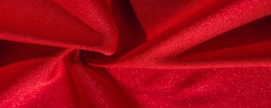 Kırmızı ipek. Soyut bir arka plan olarak, lüks kırmızı ipeğin veya satenin dokusunu kullanabilirsiniz. Renkli doku, arkaplan, desen