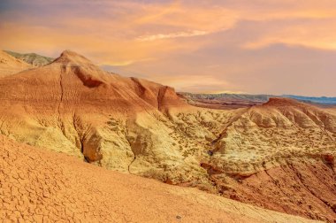 Gün batımında Kızıl Dağlar 'ın çarpıcı güzelliğinin tadını çıkar. Huzurlu ve huzurlu bir ortama dalın. Kum ve gökyüzü arasındaki nefes kesen renk dansına tanık olun.