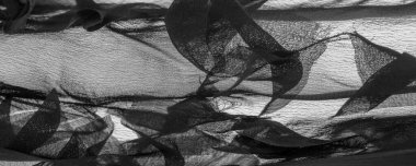 Doku. Geçmişi. Geçmişi. Yazdırılmış çizgileri olan siyah şeffaf kumaş.