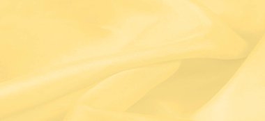 Bulanık sarı ipek kumaş. Kremsi bej rengini ve ışıldayan saten kaplamasını gösteriyor. Hala şifonun ve akıcı kumaşın tipik tazeliğini koruyor..