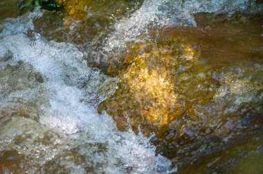 Kendini dağların dokunulmamış doğasına ver. Bir dağ deresinin huzur dolu güzelliğini tecrübe et. Her taşın karmaşık detaylarına ve parıldayan ışık oyununa hayran kal..