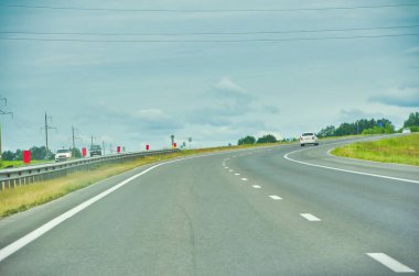 Otoyol boyunca seyahat ederken doğanın güzelliğinin tadını çıkar. Yeşillik ormanlarda rahatlatıcı bir gezintinin tadını çıkar. Yol boyunca seyahat ederken, uzun ağaçlara hayran olun..