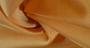 Sarı renkli ipek kumaş. Renkli ipek kumaşın dokusu arka plan olarak kullanılabilir