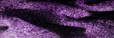 Bu kumaşın derin mor parıltılı dokusu karmaşık detaylar içinde, dokunmuş deseninde ince bir parıltı ve yumuşaklık gösteriyor. Işıldayan elementler ışığı yansıtıyor, lüks bir şey ekliyor.