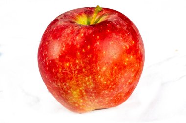 Kırmızı elma sağlık ve canlılığı sembolize eder. Vitamin ve mineral açısından zengin. Sulu ve olgun, doyurucu bir atıştırmalık için uygun. Beyaz arka plan elmanın tazeliğini vurgular..