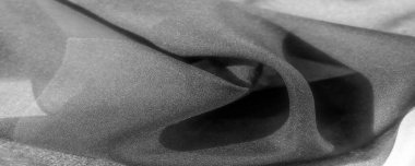 Şatafatlı kumaşın zarif ve ipek dokusunu deneyin. Sofistike siyah beyaz renkler her tasarım tarzını ön plana çıkarır. İnce kırışıklıklar derinlik ve hacim ekler,